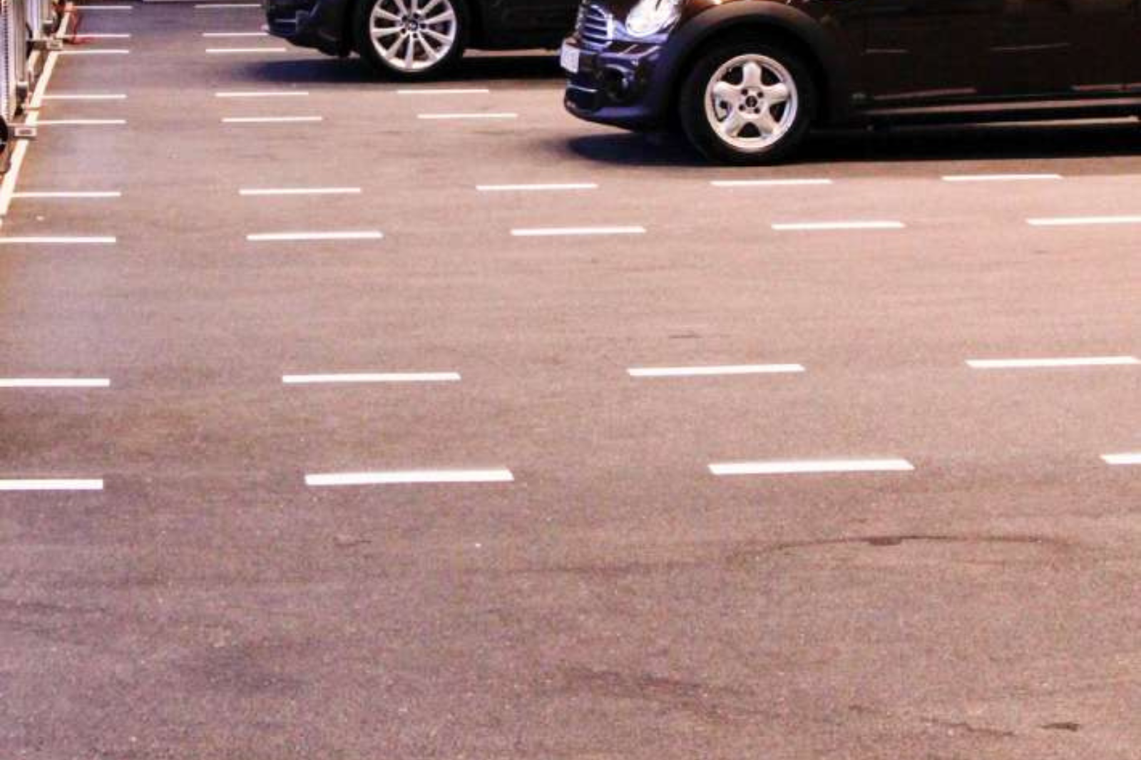 Ondergrondse parkeergarage met duurzame marmertapijt vloer en duidelijke parkeermarkeringen.